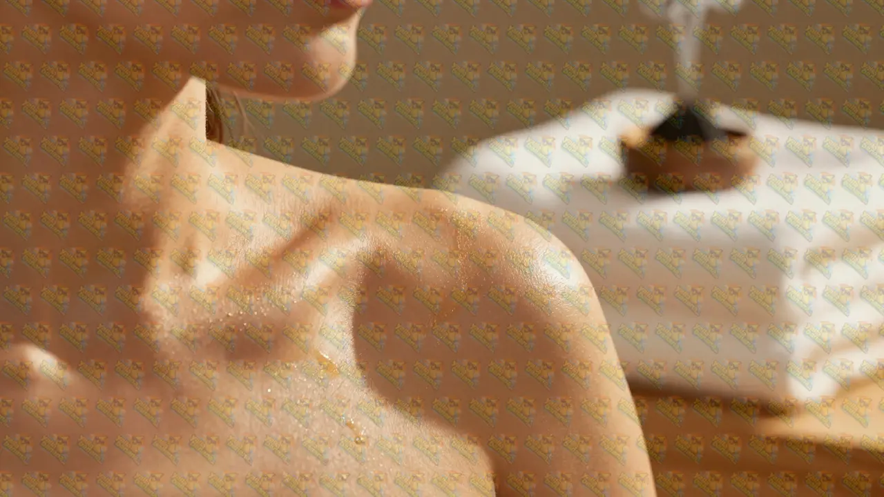 Glowing skin with shimmering gold body oil in a luxury spa setting