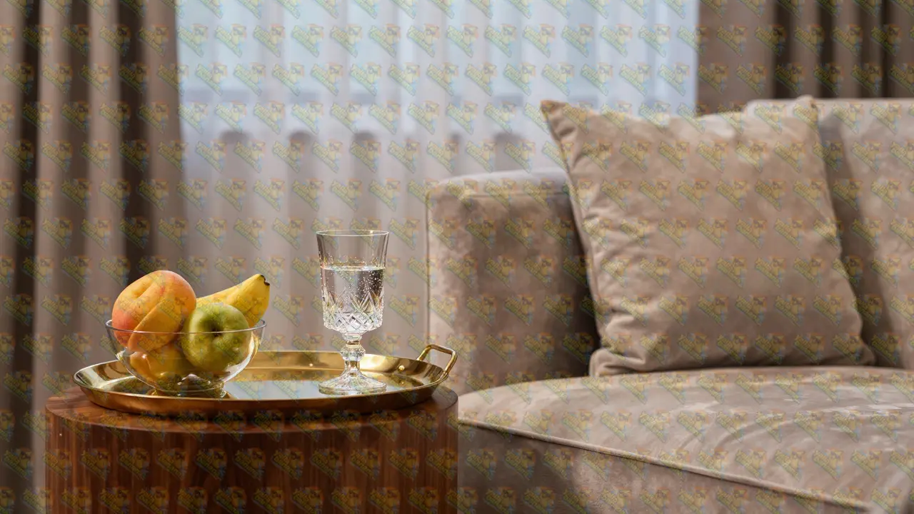 Elegant private suite interior with velvet furniture and a refreshment tray.